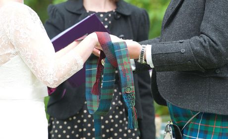 Handfasting-web-picture Tartan from each family, detail embroidered on each ribbon and with a ring and locket from the absent grandparents embroidered on with silk twist